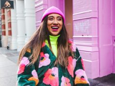 Sidewalk to Spotlight: The Evolution and Influence of the Best Street Style Looks woman in white blue and red sweater wearing pink knit cap