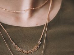 More Than Just the Finishing Touch: How Accessories Shape Identity and Style person wearing silver necklace with silver pendant