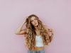 Forever in Style: The Enduring Allure of Timeless Jewelry Pieces woman standing next to pink wall while scratching her head