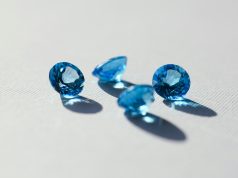 Layered Luxury: The Art of Ring Stacking and Personal Expression blue stone on white surface