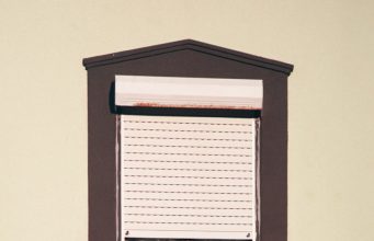 Building a Capsule Wardrobe: The Art of Simplifying Fashion shallow focus photo of clothes hanging on brown wooden window