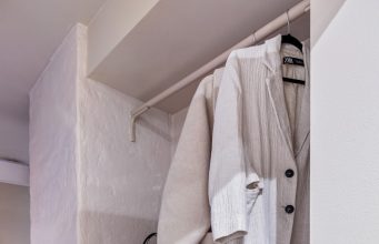 Layering Like a Pro: Mastering the Art of Versatile Fashion A white closet with shoes and a handbag
