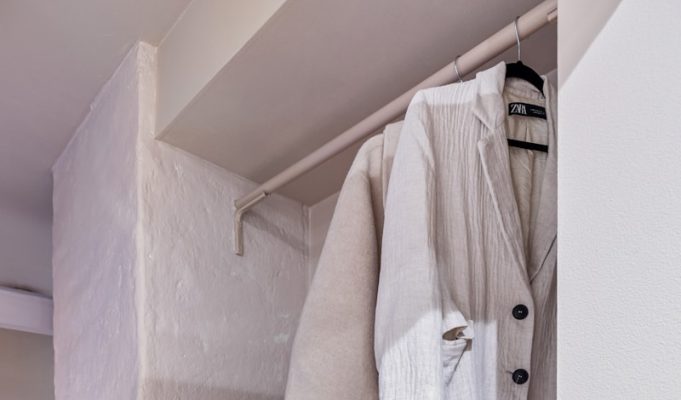 Layering Like a Pro: Mastering the Art of Versatile Fashion A white closet with shoes and a handbag