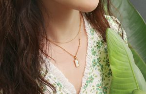The Power of Simplicity: How Neutral Pieces Quietly Define Bold, Beautiful Wardrobes a close up of a person wearing a necklace