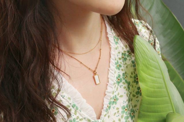a close up of a person wearing a necklace