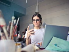 Smart Style, Big Impact: Fashion Hacks That Empower Petite Figures woman in white shirt using smartphone