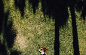 A Complete Guide to Closet Cleanout: Tips for an Organized and Functional Wardrobe woman lying on green grass during daytime