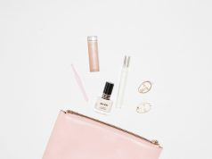 The Glow Code: A Real-World Guide to Radiant, Healthy Skin white nail polish bottle and pink leather zip pouch