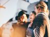 The Power of Less: Crafting an Essentials Capsule Wardrobe for Everyday Style people laughing and talking outside during daytime