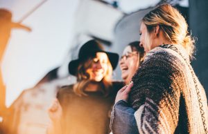 The Power of Less: Crafting an Essentials Capsule Wardrobe for Everyday Style people laughing and talking outside during daytime