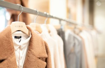 Creating Stylish Outfits From Few Pieces: Maximizing Your Wardrobe Potential brown coat hanged on white plastic hanger