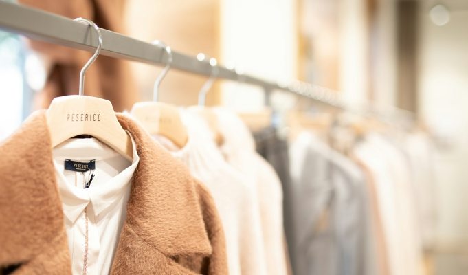 Creating Stylish Outfits From Few Pieces: Maximizing Your Wardrobe Potential brown coat hanged on white plastic hanger