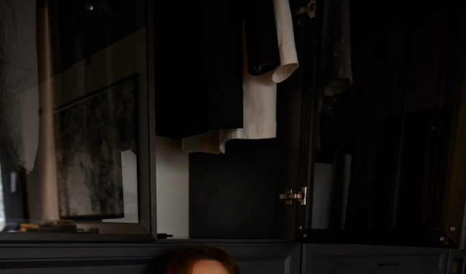 Mastering Closet Organization: Transform Your Space for Maximum Efficiency a woman sitting on the floor in a room