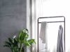 The Quiet Power of Essentials: Curating a Staple Accessories Collection That Lasts gray dress shirt hang on brown wooden rack in front of window with white curtain