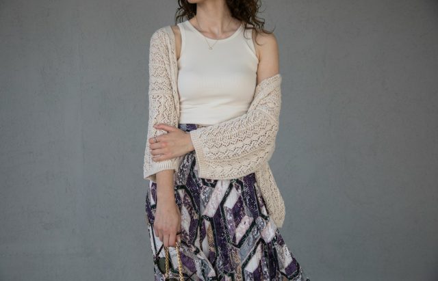 woman in white tank top and gray and white floral skirt