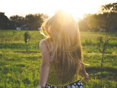 Curated Closets: Building Wardrobe Essentials Around Your Lifestyle woman walking on lawn with trees