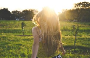 Curated Closets: Building Wardrobe Essentials Around Your Lifestyle woman walking on lawn with trees