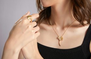 The Little Black Dress Rule: Timeless Elegance in a Changing World woman in black tube top wearing gold necklace