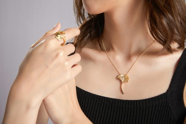 woman in black tube top wearing gold necklace